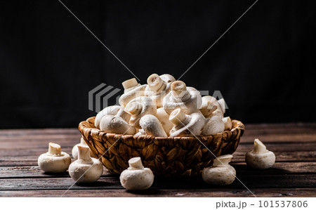 A full basket of mushrooms on the table. 101537806
