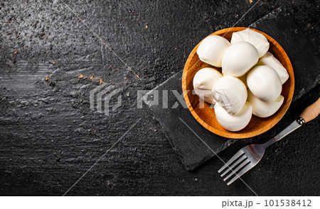 Mozzarella cheese in a wooden plate on the table. Mozzarella cheese in a wooden plate on the table. 101538412