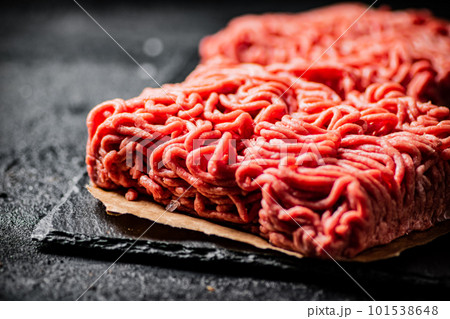 Raw minced meat on a stone board. 101538648