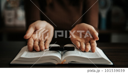Woman praying on holy bible in the morning.Woman hand with Bible praying. Christian life crisis prayer Woman praying on holy bible in the morning.Woman hand with Bible praying. Christian life crisis prayer 101539039