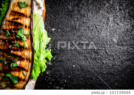 One sandwich with eggplant grilled on the table. 101539084