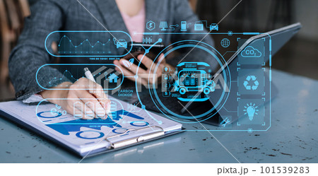 Businesswoman working virtual tablet computer twith reduce CO2 concept with icons, global warming such as reforest green factory recycle and zero carbon dioxide emission concept. Businesswoman working virtual tablet computer twith reduce CO2 concept with icons, global warming such as reforest green factory recycle and zero carbon dioxide emission concept. 101539283