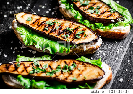 Grilled eggplant sandwich on a stone board. 101539432