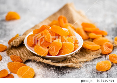 Fragrant dried apricots in a bowl on the table. 101539734