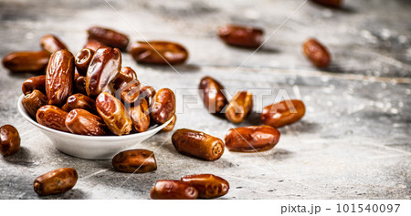 Full bowl with dates on the table. 101540097