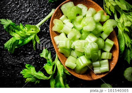 Pieces of celery in a wooden plate on the table. 101540305