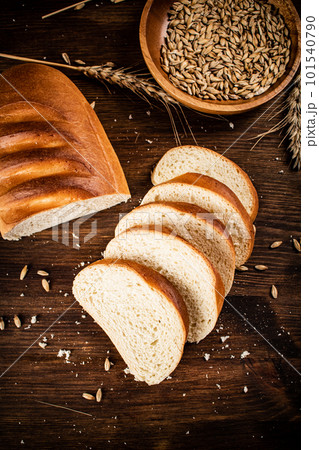 Sliced wheat bread. On a wooden background. 101540790