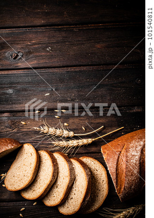 Slices of sliced bread on a table with a spike. Slices of sliced bread on a table with a spike. 101540811