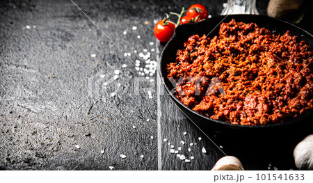 Bolognese sauce on a stone board with spices, garlic and tomatoes. 101541633