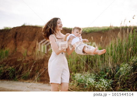 Beautiful mother and child resting on the beach. Active lifestyle. Happy childhood. 101544514