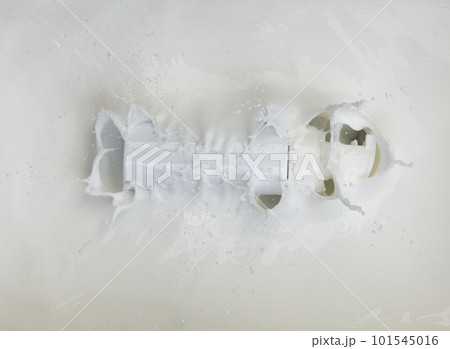 Cosmetic container white lotion droplet fly splashing. Milk lotion pour float to cosmetic bottle. Moisturizer lotion explosion spill. White background isolated high speed shutter freeze top view Cosmetic container white lotion droplet fly splashing. Milk lotion pour float to cosmetic bottle. Moisturizer lotion explosion spill. White background isolated high speed shutter freeze top view 101545016