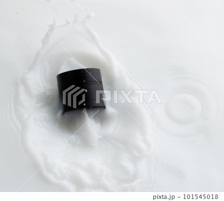 Cosmetic container white lotion droplet fly splashing. Milk lotion pour float to cosmetic bottle. Moisturizer lotion explosion spill. White background isolated high speed shutter freeze top view Cosmetic container white lotion droplet fly splashing. Milk lotion pour float to cosmetic bottle. Moisturizer lotion explosion spill. White background isolated high speed shutter freeze top view 101545018