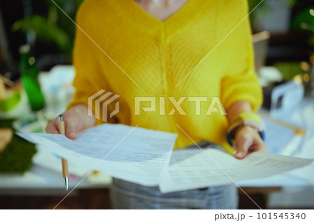 Business owner woman in green office working with documents Business owner woman in green office working with documents 101545340