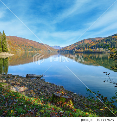 Vilshany water reservoir on the Tereblya river, Transcarpathia, Ukraine. Picturesque lake with clouds reflection. Beautiful autumn day in Carpathian Mountains. Vilshany water reservoir on the Tereblya river, Transcarpathia, Ukraine. Picturesque lake with clouds reflection. Beautiful autumn day in Carpathian Mountains. 101547025