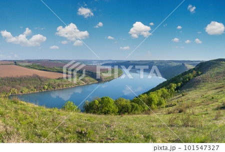 Amazing spring view on the Dnister River Canyon with picturesque rocks, fields, flowers. This place named Shyshkovi Gorby, Nahoriany, Chernivtsi region, Ukraine. Amazing spring view on the Dnister River Canyon with picturesque rocks, fields, flowers. This place named Shyshkovi Gorby, Nahoriany, Chernivtsi region, Ukraine. 101547327