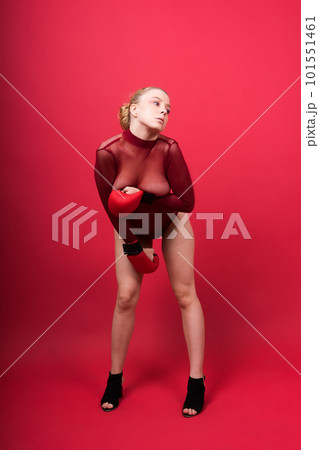 Seductive young and fit female fighter posing in gloves in studio Seductive young and fit female fighter posing in gloves in studio 101551461
