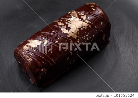 Delicious sweet cheese with syrup covered with chocolate and nuts 101553524