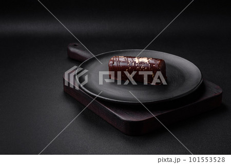 Delicious sweet cheese with syrup covered with chocolate and nuts 101553528