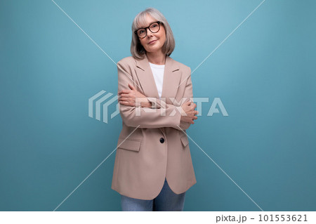 60s business woman in a jacket stands confidently on a bright background with copy space 60s business woman in a jacket stands confidently on a bright background with copy space 101553621
