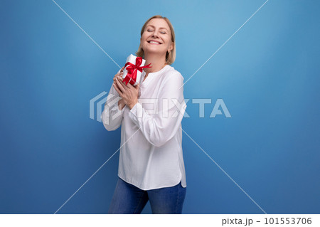 happy 50s woman received surprise gift in box on studio background 101553706