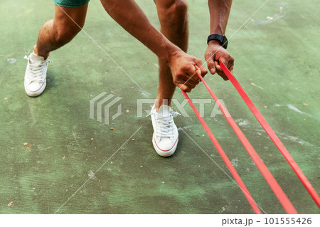 a man doing with rubber bands a man doing with rubber bands 101555426