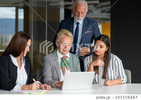 Mature businessman leader mentor talking to diverse colleagues team listening to caucasian ceo. Mature businessman leader mentor talking to diverse colleagues team listening to caucasian ceo. 101556887
