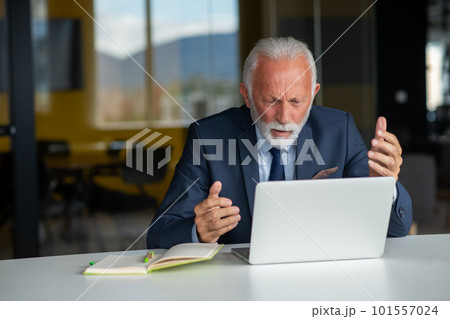 Handsome smiling senior man while sitting at his cozy workplace with laptop at home, retired male chatting with friends in social media, Handsome smiling senior man while sitting at his cozy workplace with laptop at home, retired male chatting with friends in social media, 101557024