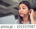 Young friendly operator woman agent with headsets working in a call centre. 101557087