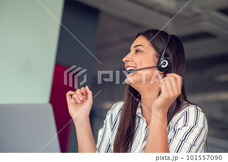 Young friendly operator woman agent with headsets working in a call centre. 101557090