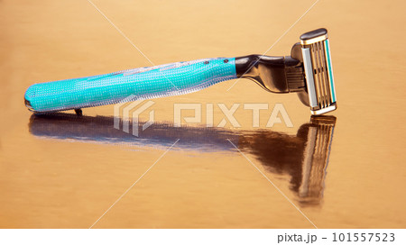 razor cassette on golden background. manual face shaving machine. stubble blade. depilation 101557523