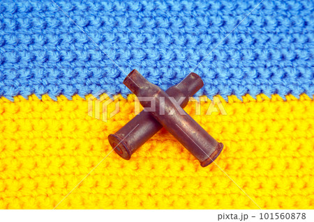 used cartridge cases from a machine gun cartridge against the background of the Ukrainian flag 101560878