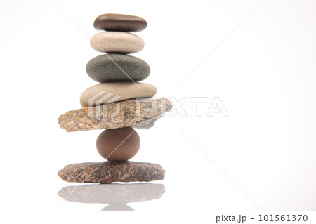 pyramid of stacked stones on a white background. stabilization and balance in life 101561370