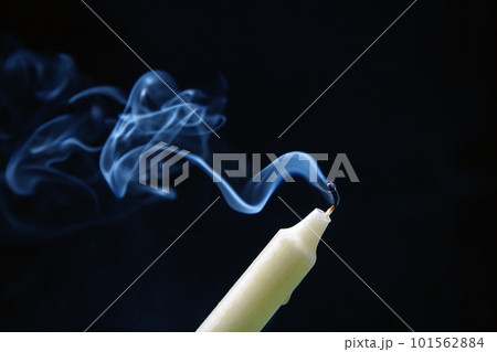 Smoke from an extinguished candle on a dark background. Smoke from an extinguished candle on a dark background. 101562884
