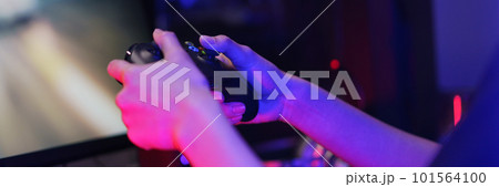 Hand of female cyber hacker gamer holding controller joystick to playing games on computer 101564100