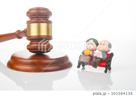 Miniature people. Elderly couple of people near the gavel of law and justice 101564138