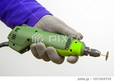 Engraving tool for cutting and processing metal and other objects in hand on a white background 101564550
