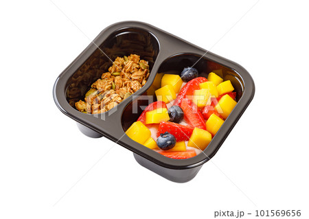Dessert of cream, mango, strawberries and muesli on a white background. Dessert of cream, mango, strawberries and muesli on a white background. 101569656