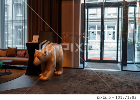Sculpture of a bear at the entrance to the luxury hotel. Modern interior design. Sculpture of a bear at the entrance to the luxury hotel. Modern interior design. 101571383
