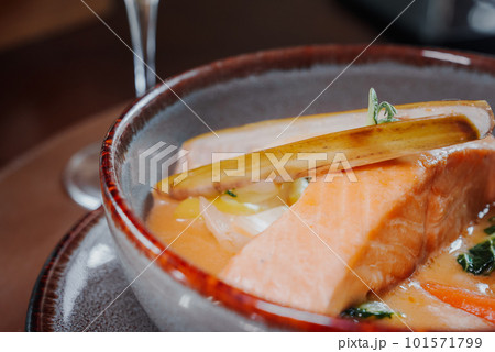 Fried salmon steak with potatoes and vegetables and spicy sauce. Vegeterian dish. Fried salmon steak with potatoes and vegetables and spicy sauce. Vegeterian dish. 101571799