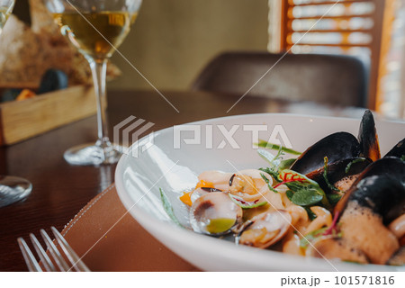 Close up view of the grilled scallop on a plate with mussels. Close up view of the grilled scallop on a plate with mussels. 101571816