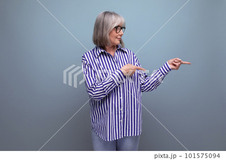 smart stylish mature 60s woman with gray hair on bright studio background with copy space 101575094