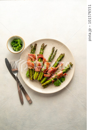 Wrapped asparagus with bacon in a plate. Top view Wrapped asparagus with bacon in a plate. Top view 101576551