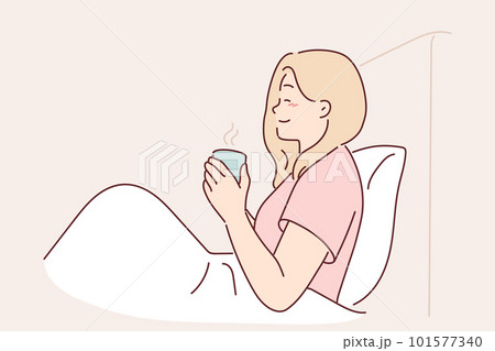 Woman is drinking coffee sitting in bed under blanket enjoying morning weekend and good mood 101577340