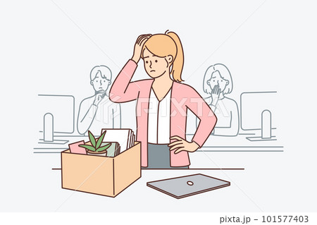 Upset woman standing near table with box after dismissal of manager or secretary position 101577403