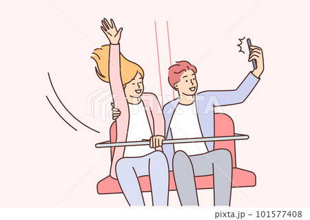 Happy couple ride attractions in park and take selfie for family photo album or love story video 101577408
