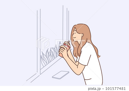 Happy woman drinking juice from disposable cup with straw sitting near window in cafe Happy woman drinking juice from disposable cup with straw sitting near window in cafe 101577481