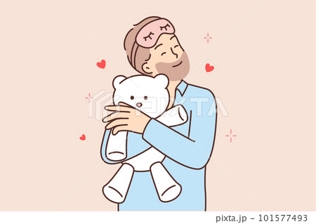 Funny bearded man hugging teddy bear before going to bed feeling attached to gift toy 101577493