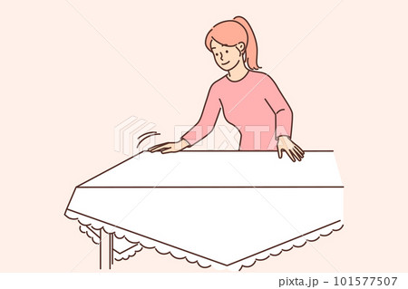 Woman housewife sets table with white tablecloth preparing for festive dinner or lunch with family 101577507