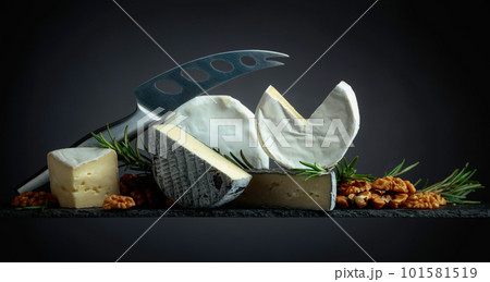 Various soft cheeses with walnuts and rosemary. 101581519