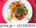 Grilled beef steak with chanterelles and vegetables on plate, top view 101582654